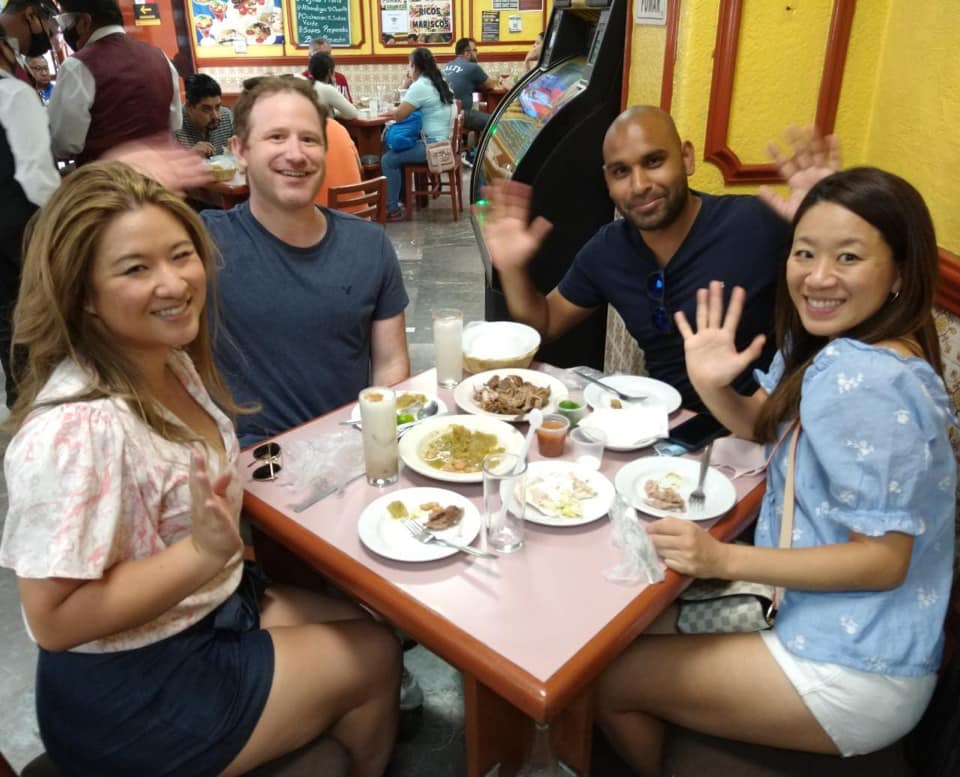 a group of people sitting at a table in a restaurant