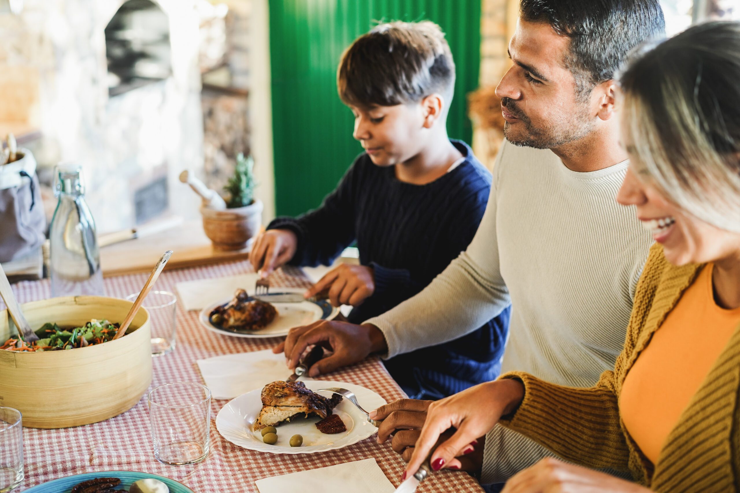 Mexican family eating at table