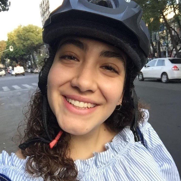 a close up of a girl wearing a hat and smiling at the camera